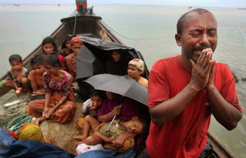 FILE - In this June 13, 2012 file photo, a Rohingya Muslim man who fled Myanmar to Bangladesh to escape religious violence, cries as he pleads from a boat after he and others were intercepted by Bangladeshi border authorities in Taknaf, Bangladesh. She is known as the voice of Myanmar's downtrodden but there is one oppressed group that Aung San Suu Kyi does not want to discuss. For weeks, Suu Kyi has dodged questions on the plight of a Muslim minority known as the Rohingya, prompting rare criticism of the woman whose struggle for democracy and human rights in Myanmar have earned her a Nobel Peace Prize, and adoration worldwide. (AP Photo/Anurup Titu, File)