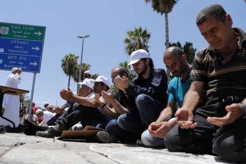 Muslim worshippers pray outside Damascus Gate, a main entrance to Jerusalem's Old City, on July 14, 2017, after the Al-Aqsa mosque was closed for Friday prayers by Israeli authorities following a shooting attack in the area. Two Israeli police officers shot when Arab assailants opened fire in Jerusalem's Old City have died from their wounds, authorities said. / AFP PHOTO / Thomas COEX
