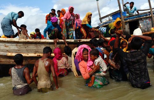 Rohingya refugees get off a boat after crossing the Bangladesh-Myanmar border through the Bay of Bengal, in Shah Porir Dwip, Bangladesh September 11, 2017. REUTERS/Danish Siddiqui