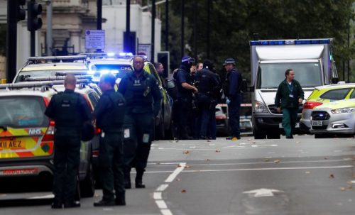 Police officers stand in the road near the Natural History Museum, after a car mounted the pavement injuring a number of pedestrians, in London